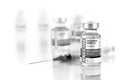 Coronavirus COVID-19 Vaccine Vials and Syringe On Reflective Surface Royalty Free Stock Photo