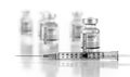 Coronavirus COVID-19 Vaccine Vials and Syringe On Reflective Surface Royalty Free Stock Photo