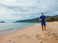 Coronavirus COVID 19. Young beautiful man doing sport performing workouts exercises and running near sea in the morning