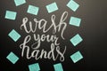 Coronavirus. Danger. Caring for cleanliness. Writing on the board- wash your hands with stickers with coronavirus. With space for