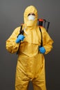 Coronavirus disinfection concept. Man in hazmat suit making disinfection