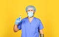 Coronavirus epidemic from china. mature doctor use syringe in respirator mask. skilled nurse make injection. health Royalty Free Stock Photo