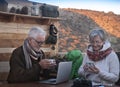 Coronavirus epidemic. The senior couple remains at home using technological devices. Worried about the Covid-19 infection spends Royalty Free Stock Photo