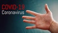Coronavirus epidemic, word COVID-19 on the background with hand, COVID-19 outbreak and coronaviruses influenza background.