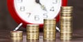 Coronavirus financial stimulus, help concept, gold money coins and alarm clock