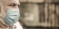 Coronavirus, illness, infection, quarantine, medical mask. Old man wearing face mask. Portrait of an old man, years old Royalty Free Stock Photo