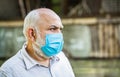 Coronavirus, illness, infection, quarantine, medical mask. Old man wearing face mask. Portrait of an old man, years old Royalty Free Stock Photo