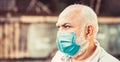 Coronavirus, illness, infection, quarantine, medical mask. Old man wearing face mask. Portrait of an old man, years old Royalty Free Stock Photo