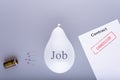 During the coronavirus its big risk for many people can lost jobs. .Pins laying on a grey background next to the cancelled contrac Royalty Free Stock Photo