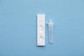 Coronavirus lateral flow home testing kit against a blue background Royalty Free Stock Photo