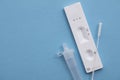 Coronavirus lateral flow home testing kit against a blue background Royalty Free Stock Photo