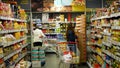 PRAGUE, CZECH REPUBLIC, JUNE 22, 2020: Coronavirus mask face food shelves pasta, spices packed shelf shop shopping cart