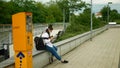 OLOMOUC, CZECH REPUBLIC, JUNE 22, 2020: Coronavirus mask face tram streetcar stop tram asian girl bench sitting people Royalty Free Stock Photo