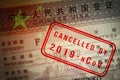 Coronavirus covid-19 epidemic. China closing borders and restricted access. Chinese visa closeup with stamp mark Cancelled by