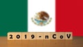 Coronavirus 2019-nCov words made of wood blocks. Covid 19 concept background with Mexico flag