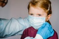 Coronavirus. Nurse, doctor in a protective suit, wearing medical mask on face for child. Preventive measures against Covid-19