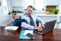 COVID-19 school lockdowns and remote working. Stressed man trying to work from home with bored son Royalty Free Stock Photo