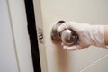 Virus and recovery concept, Opening a door. closeup on a hand touching a doorknob with glove to avoid infection Royalty Free Stock Photo