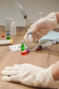 Coronavirus outbreak, Virus and recovery concept, there are hands with gloves, vaccine bottles with red or green liquid Royalty Free Stock Photo