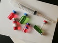 Coronavirus outbreak, Virus and recovery concept, top view, a group of vaccine bottles with empty, red or green liquid and syringe
