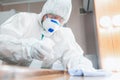 Coronavirus Pandemic. A disinfector in a protective suit and mask sprays disinfectants in the house or office