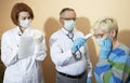 Coronavirus pandemic. Doctors in medical masks and gloves measure the temperature with a thermometer Royalty Free Stock Photo