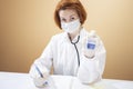 Coronavirus pandemic. Doctors in medical masks and gloves measure the temperature with a thermometer Royalty Free Stock Photo