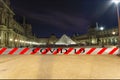 Coronavirus in Paris, France. COVID-19 sign. Concept of COVID pandemic and travel in Europe. The Louvre Palace Royalty Free Stock Photo