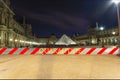 Coronavirus in Paris, France. Quarantine sign. Concept of COVID pandemic and travel in Europe. The Louvre Palace by night Royalty Free Stock Photo