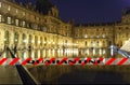 Coronavirus in Paris, France. Quarantine sign. Concept of COVID pandemic and travel in Europe. The Louvre Palace by night Royalty Free Stock Photo