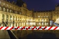 Coronavirus in Paris, France. Quarantine sign. Concept of COVID pandemic and travel in Europe. The Louvre Palace by night Royalty Free Stock Photo