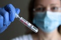 Coronavirus PCR test tube in doctor hand, woman in face mask holds COVID-19 swab collection kit