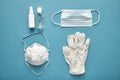 Coronavirus prevention disposable surgical masks, medical respirator, latex gloves, and pocket hand sanitizer gel for Royalty Free Stock Photo