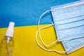 Coronavirus prevention medical surgical masks, hand sanitizer for hygiene corona virus protection on Ukrainian flag. Quarantine Royalty Free Stock Photo