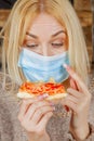Coronavirus, protect yourself, air pollution pm2.5 and risk of public places. Beautiful woman can`t eat pizza at restaurant
