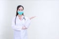 An Asian female doctor Standing with pickpocket. wearing a white robe, wearing a mask and