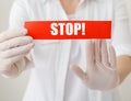 Coronavirus quarantine, red warning sign with text Stop, doctor show stop hands gesture for stop corona virus outbreak. Doctor Royalty Free Stock Photo