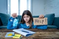 Coronavirus school closures and lockdown. Bored kid with face mask studying online class at home Royalty Free Stock Photo