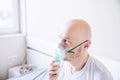 Coronavirus sick man breathing with oxygen mask. Patient in hospital. Royalty Free Stock Photo