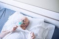 Coronavirus sick man breathing with oxygen mask. Patient in hospital. Royalty Free Stock Photo
