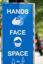 A coronavirus sign saying hands, face, space, reminding people of what the rules are as lockdown restrictions ease