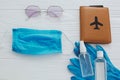 Coronavirus summer 2020. Blue face mask, gloves, antiseptic and disinfectant, passport, sunglasses on white background. Safe Royalty Free Stock Photo