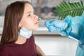 Coronavirus Test,A medical professional taking a nasal swab for a coronavirus sample from a potentially infected teenage girl