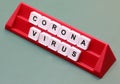 Coronavirus text made with plastic tiles on a red lectern d Royalty Free Stock Photo