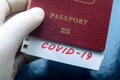 Coronavirus and travel concept. Note COVID-19 and passport. Novel corona virus outbreak. The spread of epidemic from Wuhan, China Royalty Free Stock Photo