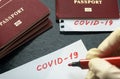 Coronavirus and travel concept. Note COVID-19 and passport. Novel corona virus outbreak. Spread of epidemic from Wuhan, China Royalty Free Stock Photo