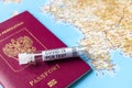 Coronavirus, travel and test concept, tube for COVID-19 PCR testing and passport on tourist map Royalty Free Stock Photo