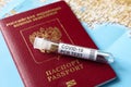 Coronavirus, travel and test concept, tube for COVID-19 PCR testing and Russian tourist passport