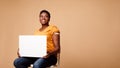 Vaccinated African Woman Showing Empty Poster Sitting On Beige Background