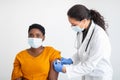 Black Lady In Mask Getting Vaccine, Nurse Sticking Bandage, Studio Royalty Free Stock Photo